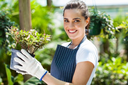 Operative trimming a hedge at the start of a job